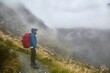 Mountain hiking trail on Routeburn track, hiker with backpack