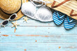 Top view of beach bag, straw hat, sunglasses, flip flops and bikini with copy space for text. Summer holiday concept