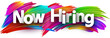 Now hiring paper word sign with colorful spectrum paint brush strokes over white.