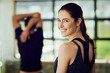 © peopleimages.com - Fitness, gym and portrait of woman with smile for cardio exercise, training and stretching. Athlete, people and happy with warm up at health club for muscle flexibility, workout or support in morning