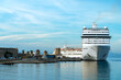 White cruise ship awaits passengers in the port of Rhodes.