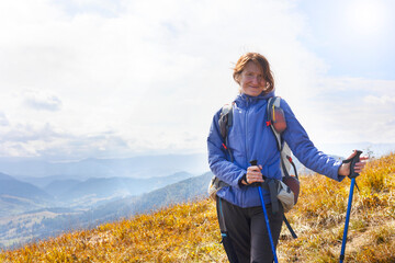 Wall Mural - girl tourist on the background of a mountain landscape