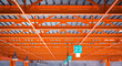 Industrial warehouse ceiling with bright orange beams