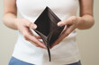 Close-up person opening empty wallet showing broke financial in debt from over expenses
