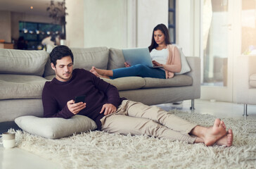 Poster - Couple, reading and relax in living room with phone, laptop and social media notification on mobile app in home. Man, woman and tech on carpet for streaming, care or chat on vacation on sofa in house