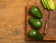 ripe organic avocado for healthy eating on wooden background