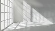 A white wall with window shadows on it. The background is a blurred shadow of the window, creating an elegant and minimal aesthetic.