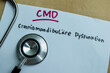 Concept of CMD - Craniomandibulare Dysfunktion write on sticky notes isolated on Wooden Table.