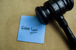 Concept of Elder Law write on sticky notes isolated on Wooden Table.