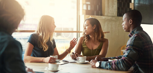 Canvas Print - Sunshine, group and friends in cafe, conversation and coffee with catch up, communication and relaxing. Reunion, man and women with sunlight, cappuccino and latte with discussion, talking or chilling