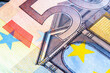 Close up fragment of 50 Euro description on banknote. Selective focus.