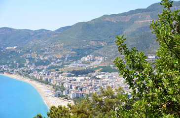 Wall Mural - a city is surrounded by mountains and a beach aerial view  