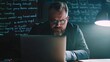 © Tana Studio - A serious businessman is focused on working on a laptop computer with many ideas written on a board in the background.