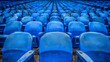   A row of blue seats in a stadium, each seat filled, atop a wooden floor