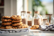 A stack of delicious chocolate chip cookies on a white plate at sunny day time. Homemade bakery concept