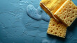 Cleaning Sponges and Soap Suds on Blue Surface