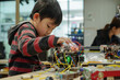 © MagnusCort - A young boy is working on a robot with a board that says ' arduino ' on it
