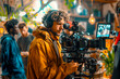 Creative Team of Filmmakers in Vibrant Studio Setting Led by Male Caucasian Videographer with Camera Surrounded by Lighting Gear and Reviewing Notes