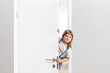 Little girl opening a door