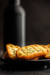 Garlic crisp bread Slices Topped With Herbs on black table.