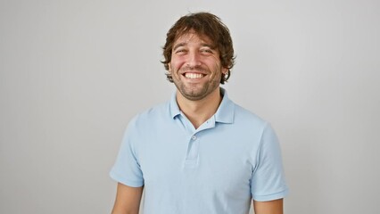 Sticker - Joyful young caucasian guy with a sexy wink, standing isolated on a white backdrop. looking at the camera, winking with a cheerful, happy face.