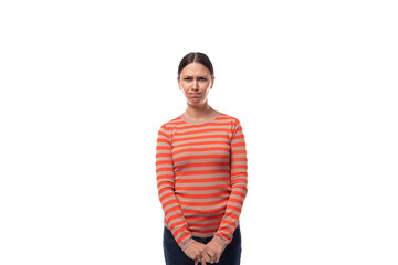 Wall Mural - sullen young adult woman with black hair dressed in an orange sweater is angry