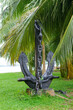 An old ship's anchor on a pedestal on the seashore. Sri Lanka.
