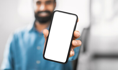 Poster - Unrecognizable man holding a modern cell phone device in his hand, looking at the screen. The background is indiscernible, focusing solely on the man and the phone.