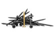 Pile of black screws and single gold screw isolated on a white background. Industry concept.
