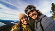 cheerful couple taking selfie photo standing on mountains.