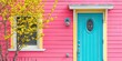 yellow tree in front of pink house with blue door 