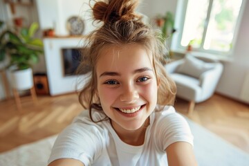 Happy teenage girl taking selfie at home