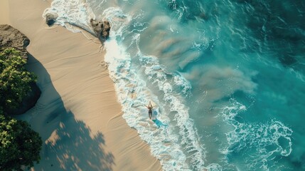 An aerial view of two individuals standing on the beach, overlooking the azure waters with surfboards in hand AIG50