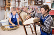 Male furniture maker working on vintage chair in workshop