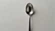 A solitary spoon rests on a pristine white background, its presence echoing a quiet, poignant narrative ai_generated