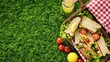 A green picnic basket filled with food items such as sandwiches, lemons, and juice placed on the grass. The ingredients are sourced from terrestrial plants and citrus fruits AIG50