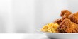 Served over a white tray over a white backdrop is organic, savory fried chicken with an additional item of mac and cheese lovely sauce and space, Generative AI.