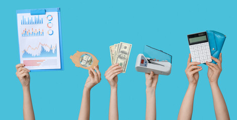 Wall Mural - Women holding clipboard with charts, money, cash counting machine, piggy bank, wallet and calculator on blue background