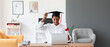 Happy African-American student on his graduation day at home. Concept of online education