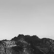 Top of the rock against the sky. Monochrome nature background with space for text. Coastal mountain stone.
