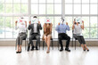 © Pixel-Shot - Young people holding paper sheets with different marks while waiting for job interview in office