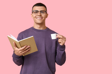 Poster - Handsome young man reading book and drinking coffee on pink background