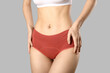 © Pixel-Shot - Young woman in panties on grey background