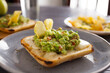 Morning toast with melted cheese and guacamole