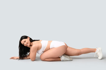 Poster - Body positive woman in underwear sitting on light background