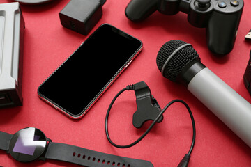 Wall Mural - composition with modern devices on color background, closeup