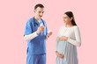 © Pixel-Shot - Young pregnant woman and doctor with pill bottles on pink background