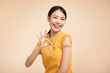 Healthy asian woman getting vaccinated immunity giving ok hand sign on beige background, concept of recommended inoculation, vaccination,