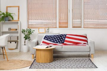 Interior of light room with sofa, coffee table and USA flag