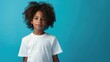 © Naknakhone - Male child, boy wearing bella canvas white shirt mockup, at blue background. Design shirt template, print presentation mock-up. copy space for text.